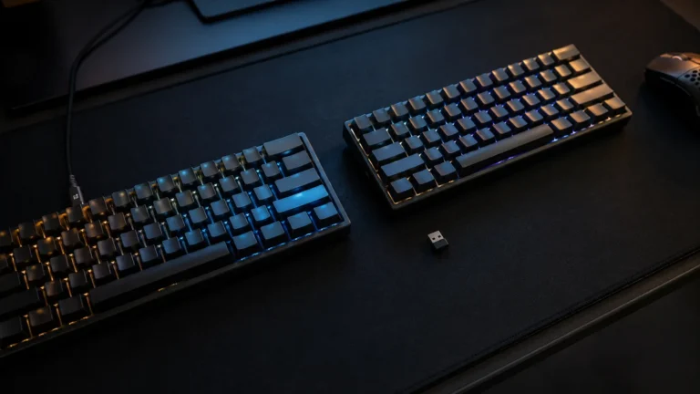 Wired and wireless mechanical keyboards side by side on a gaming desk, illustrating the wired versus wireless debate in pro esports