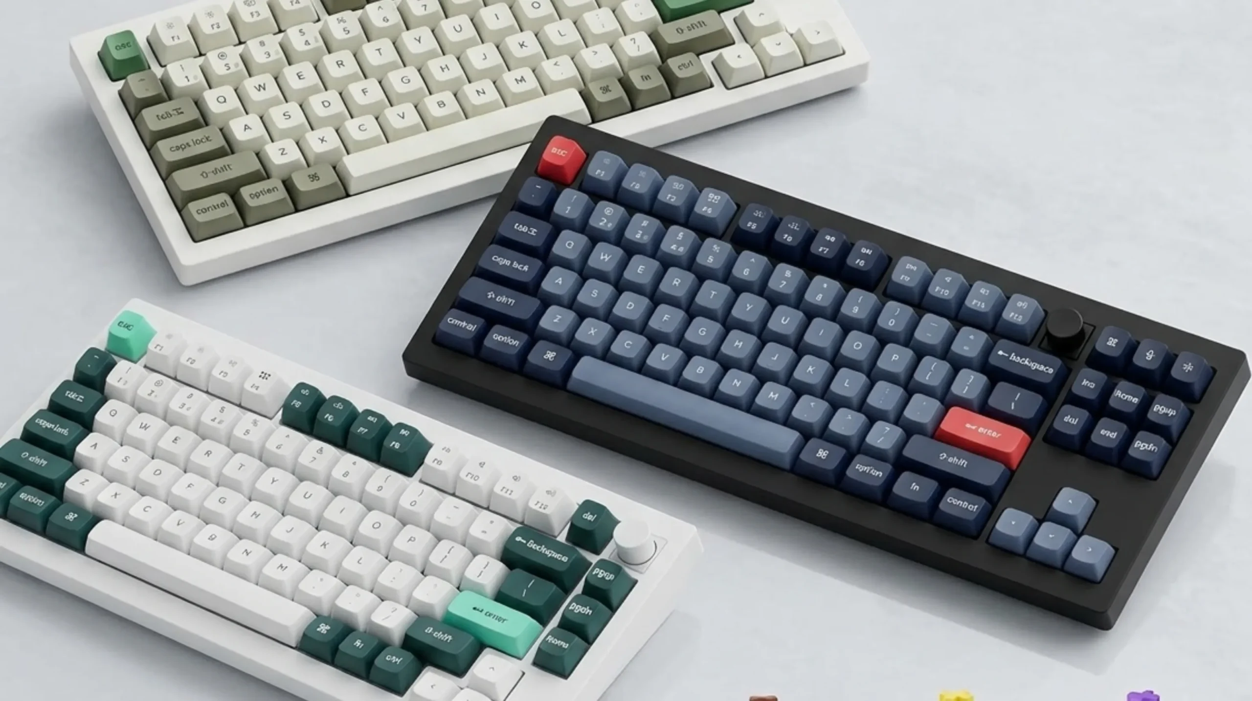 Mechanical keyboard with tactile switches next to a Hall effect gaming keyboard, side-by-side comparison on a desk