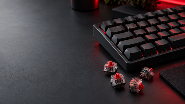 Cherry MX Red style linear keyboard switches beside a mechanical gaming keyboard